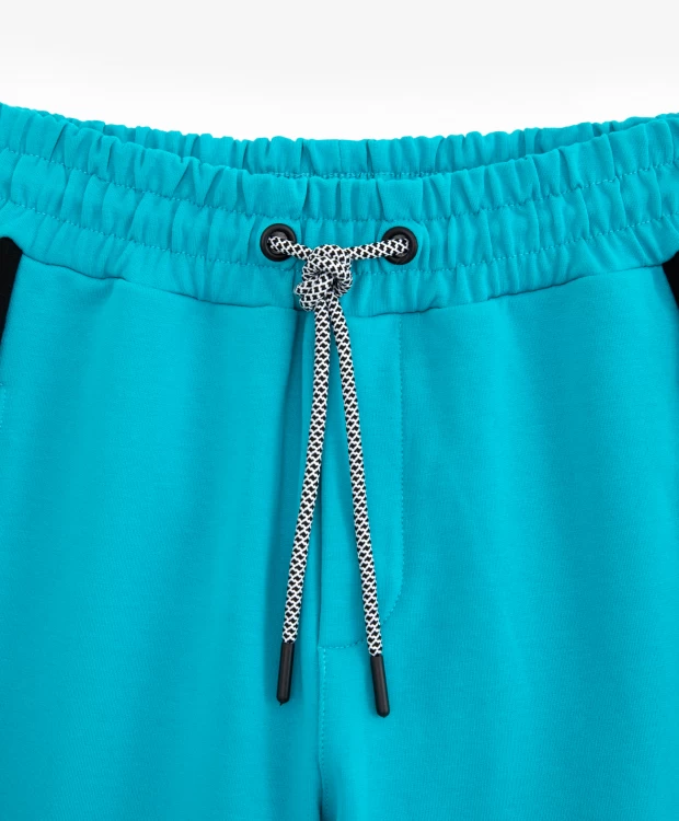 фото Брюки-джоггеры с лампасами и принтом бирюзовые gulliver (164)