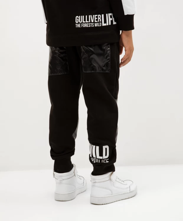 фото Брюки из футера с глянцевыми накладками черные gulliver (128)